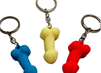 Drei bunte silikon-penis-schlüsselanhänger in blau gelb und rot in phosphoreszenzfarben von diablo picante