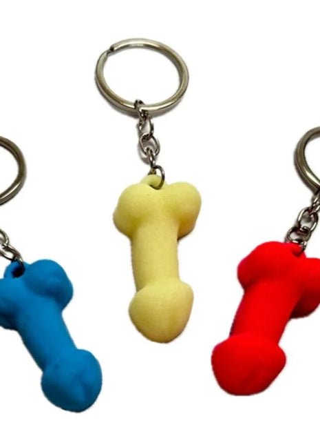 Drei bunte silikon-penis-schlüsselanhänger in blau gelb und rot in phosphoreszenzfarben von diablo picante