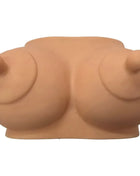 Beiges silikon brustförmiges sparschwein namens diablo picante hellton für massagezwecke