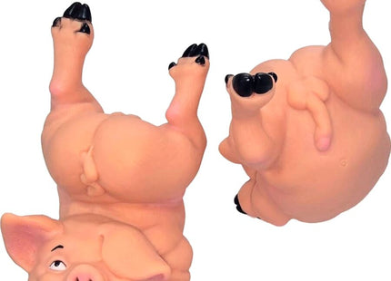 Pinkes gummispardose sparschwein diablo picante in spielerischer kopfstand pose mit schwarzen hufen und augen