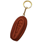 Brauner vagina-schlüsselanhänger diablo picante mit goldfarbenem metallring und kette in dunkler tonfarbe