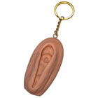 Peachfarbener silikon vagina-schlüsselanhänger diablo picante mit goldfarbenem ring und kette in hellton