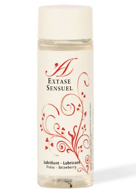 Eine klare glasflasche mit weißem deckel und rotem blumendesign, extase sensuel erdbeer geschmacktes gleitmittel 100 ml