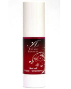 Ein schlanker weißer zylinderflasche mit rotem etikett und silbernen blumendesigns extase sensuel hot oil fraise erdbeeröl 30 ml
