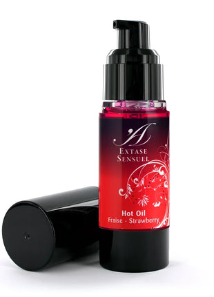 Rotes glasfläschchen extase sensuel wärmendes öl erdbeer fraise mit schwarzem pumpverschluss vor weißem hintergrund