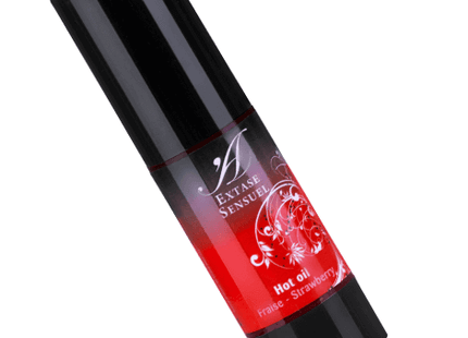 Schwarze zylinderförmige flasche mit rotem verlaufsetikett und weißem blumendesign für extase sensuel heißöl erdbeer 30 ml