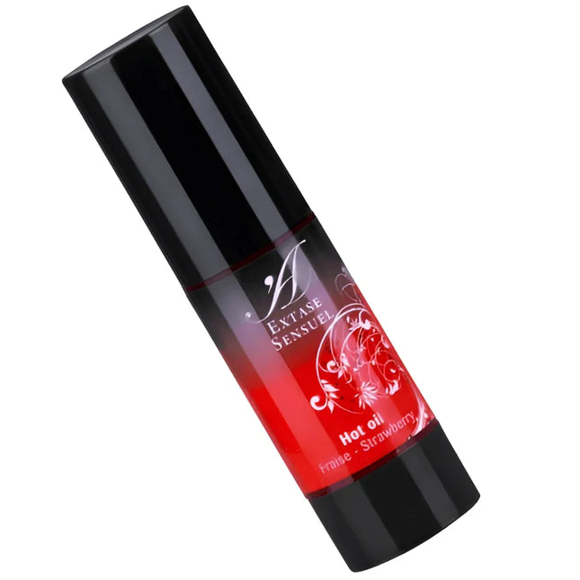 Schwarze zylinderförmige flasche mit rotem verlaufsetikett und weißem blumendesign für extase sensuel heißöl erdbeer 30 ml