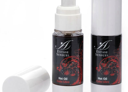 Zwei schwarze und weiße pumpflaschen extase sensuel hot oil mit roten blumendesigns für kubafrei wärmestmmulierendes öl 30 ml