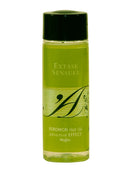 Eine klare glasflasche mit schwarzem verschluss enthält lime-grünes massageöl extase sensual mit wärmeeffekt und mojito pheromonen