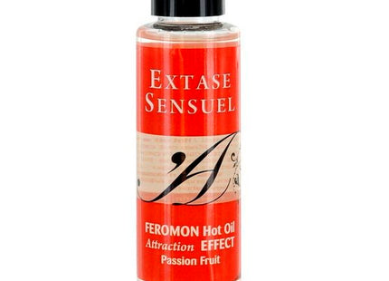 Ein klares glasfläschchen mit schwarzem verschluss und rotem beige etikett extase sensuel passionsfrucht pheromon massageöl 100 ml