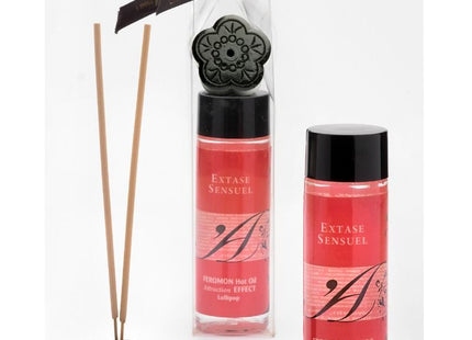 Schwarze floral geformte diffuser basis mit holzstäbchen und zwei rosa etikettierten extase sensuel massageolflaschen 100 ml