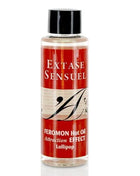 Eine klare flasche mit schwarzem deckel enthält rote etikettierte extase sensuel massageöl mit wärmeeffekt und pirulet pheromonen