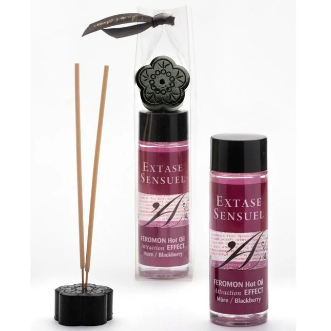 Schwarzer diffuser in floraldesign mit holzstäbchen und passendem sockel verpackt mit schwarzer schleife extase sensual massageöl mit wärmeeffekt und brombeerpheromonen 100 ml