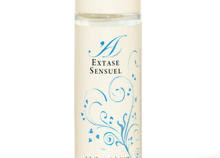 Eine klare glasflasche mit cremefarbenem deckel und etikett, blauen floralen mustern und extase sensuel branding, natürliches schmiermittel 100 ml