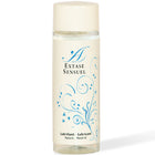 Eine klare glasflasche mit cremefarbenem deckel und etikett, blauen floralen mustern und extase sensuel branding, natürliches schmiermittel 100 ml