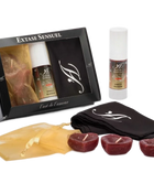 Schwarze geschenkbox extase sensuel mit klarem fenster zeigt flasche tuch und herzförmige kerzen für orale leidenschaft