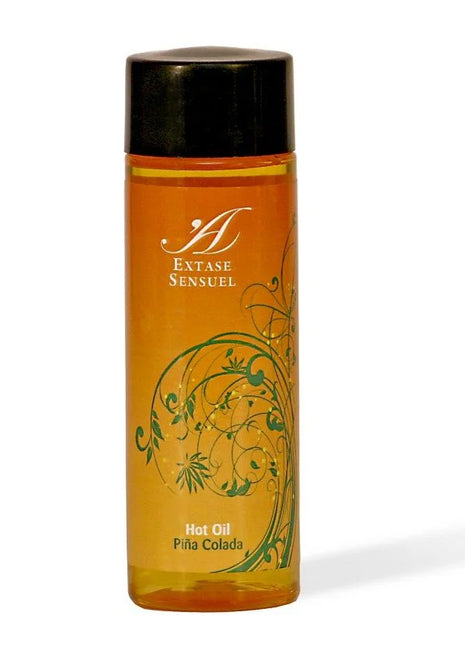 Orange glasflasche mit schwarzem deckel und grünem floralen design extase sensuel piña colada warmes stimulierendes öl 100 ml