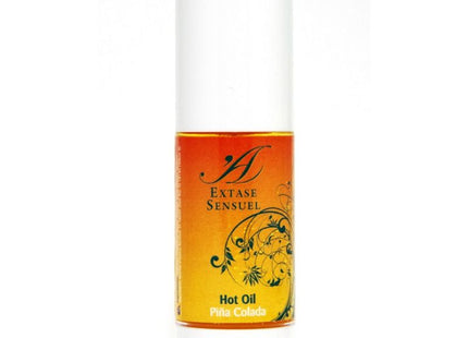 A sleek white cylindrical bottle with amber piña colada warm stimulating oil from extase sensuel with floral label