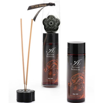 Schwarzer blumenförmiger reed diffuser mit passendem deckel und zwei bernsteinfarbenen extase sensual schokoladen und orangen ölbottles