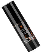 Schwarze zylinderflasche extase sensual massageöl im schokoladen-orange duft mit gold-braunem etikett 30 ml