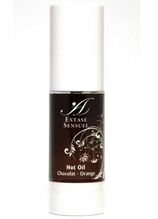 Ein eleganter weißer zylinderförmiger flakon mit dunkelbraunem etikett und silbernen floralen mustern extase sensuel öl schokolade-orange duft 30 ml