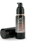 Schwarze pumpflasche extase sensuel heißes kolenöl mit silbernem etikett und roten floralen mustern 30 ml