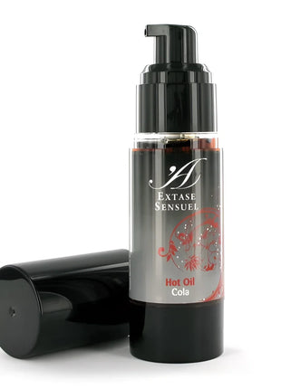 Schwarze pumpflasche extase sensuel heißes kolenöl mit silbernem etikett und roten floralen mustern 30 ml