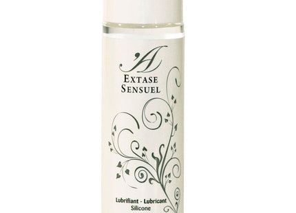 Eine klare Glasflasche mit weißem Verschluss und schwarzem Blumenmuster, extase sensual silikon gleitmittel 100 ml