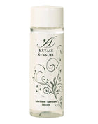 Eine klare Glasflasche mit weißem Verschluss und schwarzem Blumenmuster, extase sensual silikon gleitmittel 100 ml