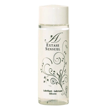 Eine klare Glasflasche mit weißem Verschluss und schwarzem Blumenmuster, extase sensual silikon gleitmittel 100 ml