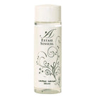 Eine klare Glasflasche mit weißem Verschluss und schwarzem Blumenmuster, extase sensual silikon gleitmittel 100 ml
