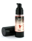 A sleek black pump bottle with clear glass and pinkish extase sensuel cream labeled with a red heart