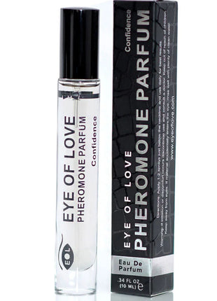 Klare glas-rollerflasche mit schwarzem deckel und weißem etikett eye of love pheromon parfum von confidence neben schwarzer box