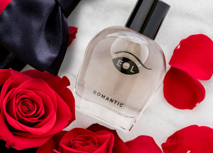 Klarer glasparfümflakon mit schwarzem verschluss und minimalistischem augenlogo etikettiert romantic von eol