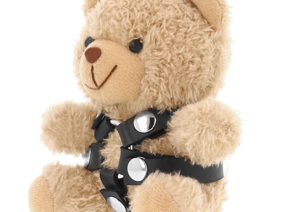 Ein kuscheliger brauner teddybär mit schwarzem lederharness und silberfarbenen schnallen im fetish submissive stil