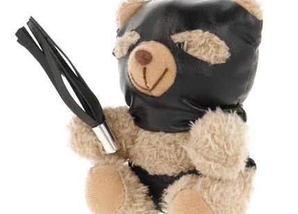 Ein plüschiger teddy mit beigem fell, schwarzer ledermaske und schwarzem lederflogger fetisch submissive modell 7