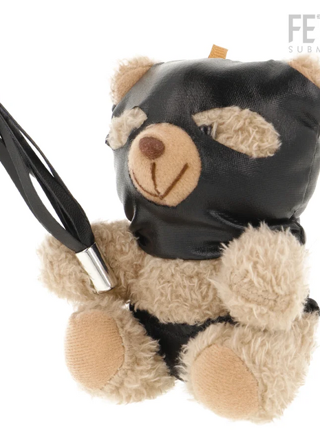Ein plüschiger teddy mit beigem fell, schwarzer ledermaske und schwarzem lederflogger fetisch submissive modell 7