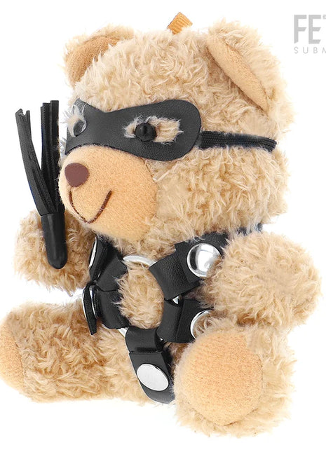 Ein beiger plüsch-teddybär mit schwarzer ledermaske und harness hält einen schwarzen lederflogger, fetish submissive modell 2