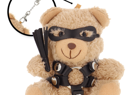 Tan plüsch teddy bear in schwarz ledermaske und harness mit silber metall und peitsche fetisch submissive bdsm modell