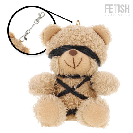 Ein beiger plüsch teddy mit schwarzen stoffriemen am gesicht und körper im fetish submissive winnie teddybär bdsm modell 6