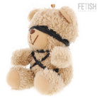Ein plüschiger beiger teddy mit lockigem fell und schwarzen stoffriemen im fetish submissive winnie teddybär modell 6
