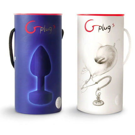 Zwei zylindrische funtOys g-plugs anal-vibrator produktboxen in blau und weiß mit leuchtender silhouette und detaillierter skizze
