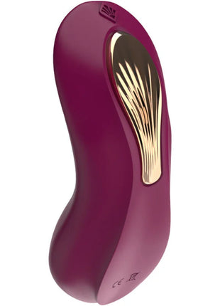 Ein eleganter, gebogener lila g spot sucker und stimulator mit goldfarbener strukturierter oberfläche und subtiler markierung