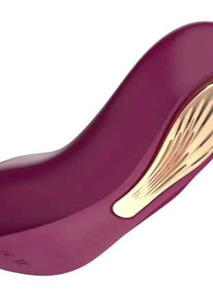 Ein eleganter, gebogener violetter und goldener g spot sucker und stimulator mit glänzendem finish aus glattem material