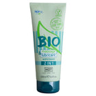 Ein hellgrüner und türkisfarbener schlauch ncp bio massage und gleitmittel 2 in 1 wasserbasierte formel mit dunkelblauem deckel