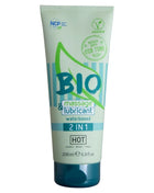 Ein hellgrüner und türkisfarbener schlauch ncp bio massage und gleitmittel 2 in 1 wasserbasierte formel mit dunkelblauem deckel