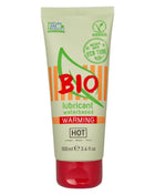 Ein blassgrünes und orangenes rohr des bio wasserbasierten wärmenden schmiermittels hot mit rotem deckel 100 ml
