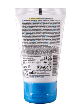 Weiße plastiktube mit blauem verschluss und mehrsprachigem etikett für hot extratreme wasserbasiertes gleitmittel 30 ml