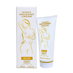 Weiße tube und passende box der intimen aufhellungscreme hot mit goldfolie und stilisiertem weiblichem motiv