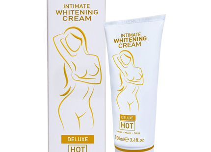 Weiße tube und passende box der intimen aufhellungscreme hot mit goldfolie und stilisiertem weiblichem motiv